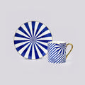 Blue and white patterned ceramic mug and matching saucer with a gold handle, shown on a light gray background.