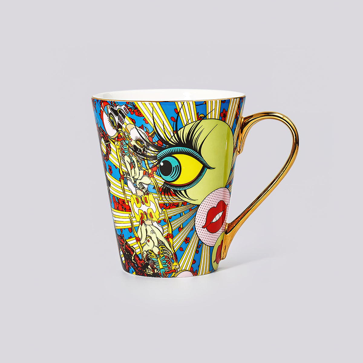 A ceramic coffee mug featuring a vibrant, multicolored pop-art illustration of a stylized eye and lips, with a metallic gold handle, set against a solid light gray background.
